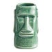 A close-up of a green ceramic Tiki mug with a face on it.