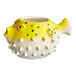 An Acopa yellow and white ceramic pufferfish mug.