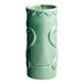 An Acopa green ceramic Tiki mug with a pattern on it.