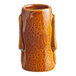 A brown ceramic Acopa Tiki shot glass with a handle.
