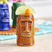 A brown Acopa ceramic Tiki mug with a lime wedge on top.