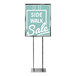 A chrome bulletin sign holder with a sign that says "Side Walk Sale" on it and a black pole.