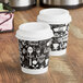 Two Choice paper coffee cups with a black and white coffee design.