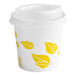 A white EcoChoice paper hot cup with yellow leaves on it.