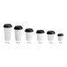 A row of white Choice paper hot cups with black lids.