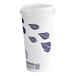 A white paper cup with purple leaves on it.