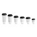 A row of white Choice double wall ripple paper hot cups with black lids.