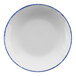 A white porcelain serving bowl with a blue sponged rim.