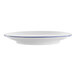 A white porcelain bread and butter plate with a blue rim.
