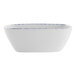 A white square porcelain bowl with blue sponged stripes on it.