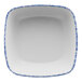 A white square porcelain bowl with blue trim.