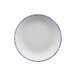 A white porcelain bread and butter plate with blue sponged accents.