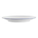 A white porcelain coupe plate with a blue rim.