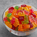 A bowl of Albanese 5 Natural Flavor Gummi Bears on a table.