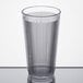 A close-up of a Carlisle clear plastic tumbler with a straight rim.