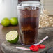 A clear Carlisle plastic tumbler with soda and a lime slice and straw.
