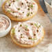 Sliced bagels on a plate with Don's Salads Lox Cream Cheese spread on top.