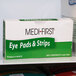 A close-up of a Medique box of 4 Med-First eye pads.