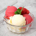 A Libbey Supreme Liner glass bowl filled with ice cream topped with raspberries and mint.