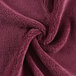 A close up of a burgundy Monarch Brands coral fleece hand towel.