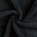 A close up of a black Monarch Brands coral fleece hand towel.