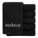 A stack of black Monarch Brands makeup wash cloths with the word makeup on them.