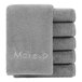 A stack of Monarch Brands gray makeup wash cloths with text on them.