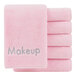 A stack of Monarch Brands pink makeup wash cloths with the word "makeup" on them.