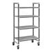 A Cambro Camshelving Elements XTRA metal shelving unit with wheels and four shelves.