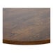 A BFM Seating Relic round walnut melamine table top with matching edge.
