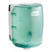 A Tork blue and white plastic center pull towel dispenser with a clear lid and green handle.