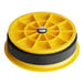 A yellow and black circular plastic container with a hole in the center.