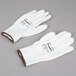A pair of small white Cordova warehouse gloves with white polyurethane palms.