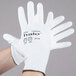 A pair of white Cordova gloves with white polyurethane palm coating and black text that reads "Halo"