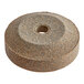 A circular sharpening stone with a hole in the middle.