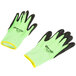 A pair of extra small Cordova warehouse gloves with green and black rubber coating.
