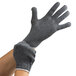 A pair of small hands wearing gray Cordova work gloves.