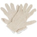 A pack of 12 pairs of beige Cordova jersey gloves.