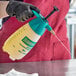 A person in black gloves using a yellow Chapin industrial cleaner and degreaser sprayer.