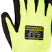 A close up of a Cordova Monarch heavy duty work glove with yellow and black stripes and a black foam latex palm coating.