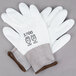A pair of white Cordova warehouse gloves with white polyurethane palms.