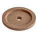 A brown circular granite stone with a hole in the middle.