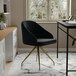 A Martha Stewart black velvet office chair with polished brass legs at a desk.
