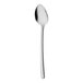 A Sola the Netherlands stainless steel demitasse spoon with a white handle.