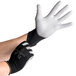 A pair of hands wearing black Cordova Cor-Touch Lite gloves with gray palms.