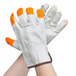 A pair of Cordova cowhide driver's gloves with orange fingertips.