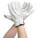 A pair of white leather Cordova driver's gloves with a black leather cuff.