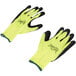 A pair of small Cordova work gloves with yellow and black fabric and green foam latex palms.