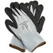 A pair of gray and black gloves with white and gray trim.