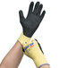 A person wearing Cordova ActivGrip Advance Kevlar gloves with black and yellow coating.